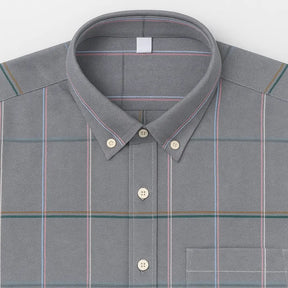 Camisa masculina Oxford cinza xadrez com listras coloridas, manga longa, dobrada, vista superior.