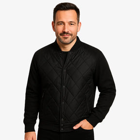 Modelo masculino usando jaqueta bomber preta acolchoada com fechamento por botões. Estilo casual elegante para dias frios. 